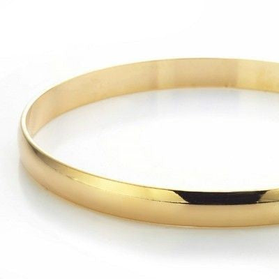 A 7mm wide 18ct heavy yellow gold plated plain bangle, showcasing its elegant design and luxurious finish, made in the USA.