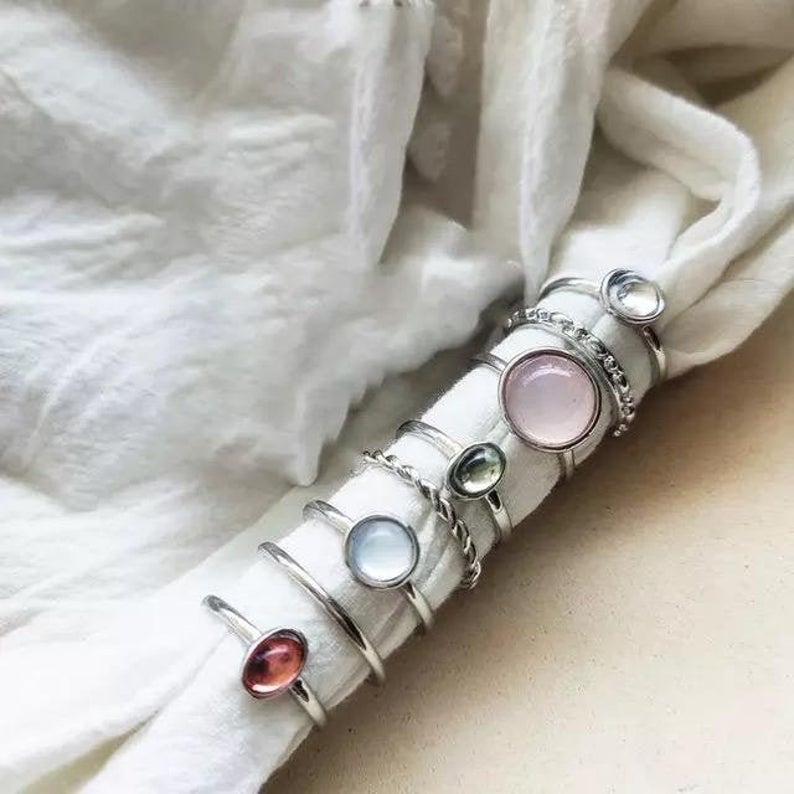 A vibrant set of 8 metallic boho rings in silver and gold, showcasing intricate designs and colorful stones, perfect for stacking.