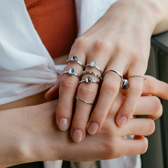 A vibrant set of 8 metallic boho rings in silver and gold, showcasing intricate designs and colorful stones, perfect for stacking.