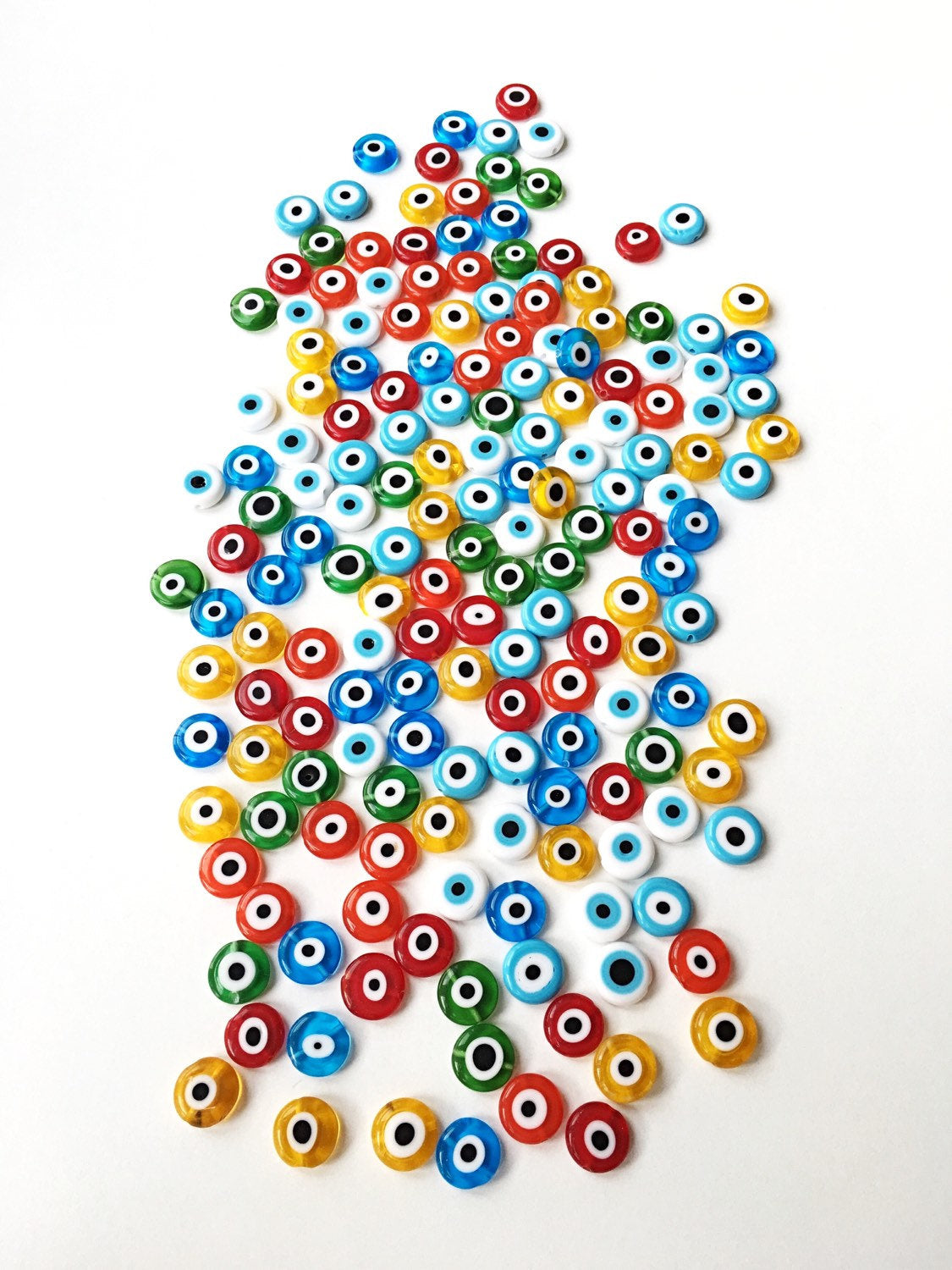 A collection of 40 handmade 8mm Turkish evil eye glass beads in various colors, showcasing their unique designs and protective symbolism.