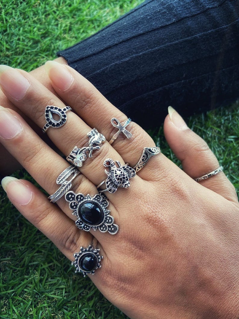A stylish 9 piece bohemian stackable beach midi tribal vintage ring set featuring elegant silver rings with unique designs.