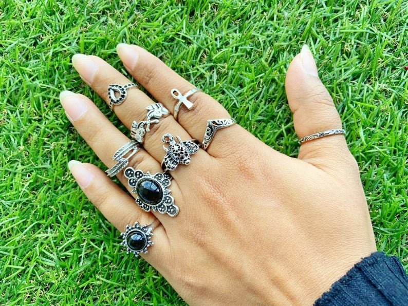 A stylish 9 piece bohemian stackable beach midi tribal vintage ring set featuring elegant silver rings with unique designs.