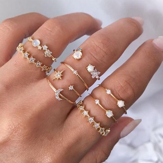 A stunning 9 piece celestial ring set featuring various gemstone crystals, elegantly plated in 18K gold, showcasing intricate designs.