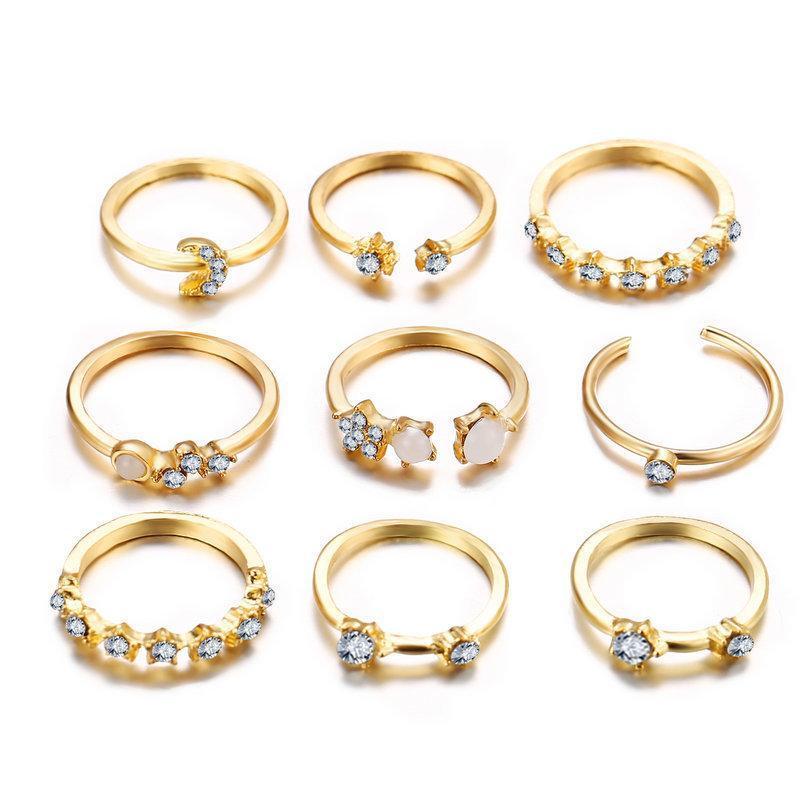 A stunning 9 piece celestial ring set featuring various gemstone crystals, elegantly plated in 18K gold, showcasing intricate designs.