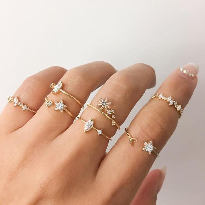 A stunning 9 piece celestial ring set featuring various gemstone crystals, elegantly plated in 18K gold, showcasing intricate designs.