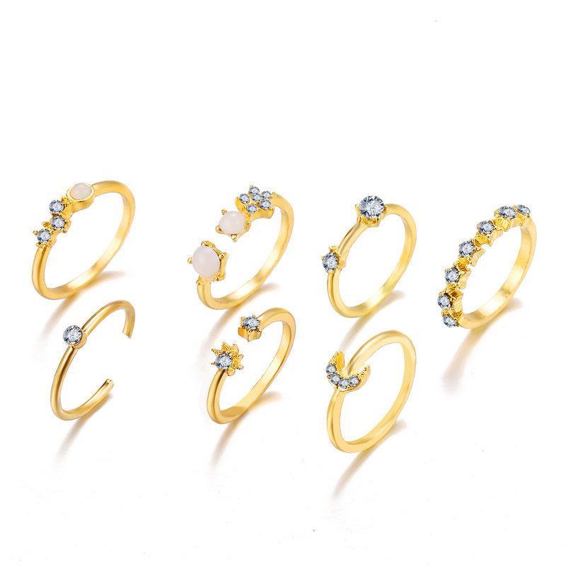 A stunning 9 piece celestial ring set featuring various gemstone crystals, elegantly plated in 18K gold, showcasing intricate designs.