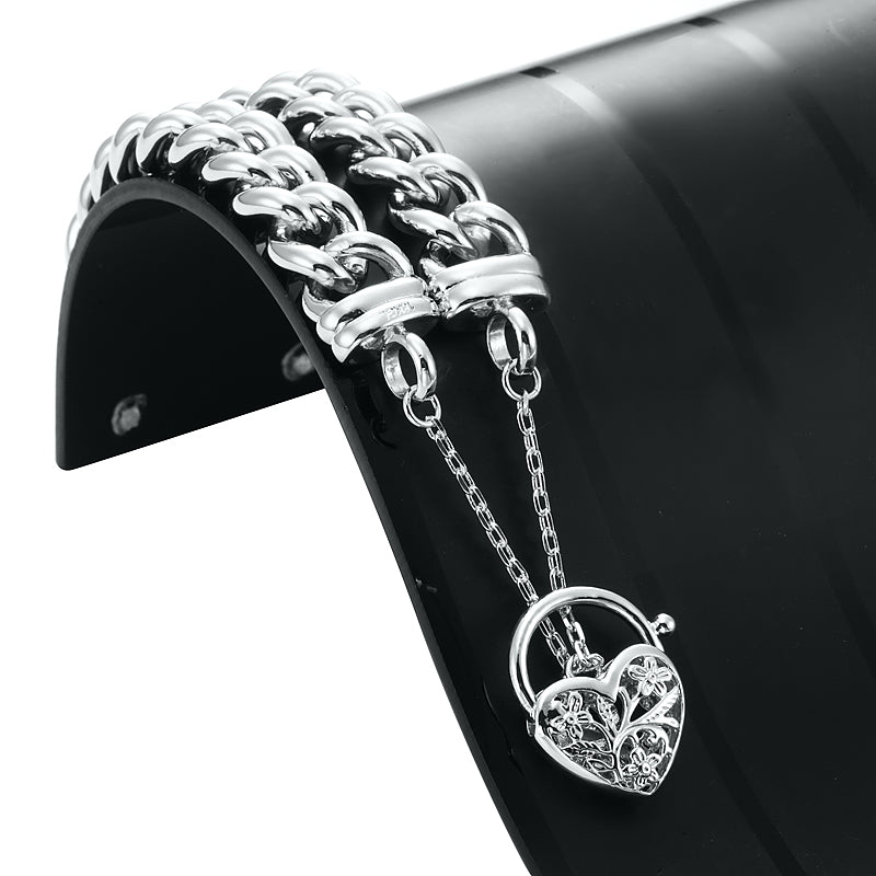 A 925 Sterling Silver Plated 12mm Euro Curb Chain Bracelet featuring a filigree locket, showcasing its elegant design and shiny finish.