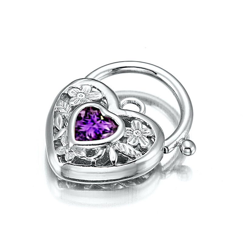 A beautifully crafted 925 Sterling Silver Plated Purple Filigree Heart Locket, showcasing intricate designs and a shiny finish.