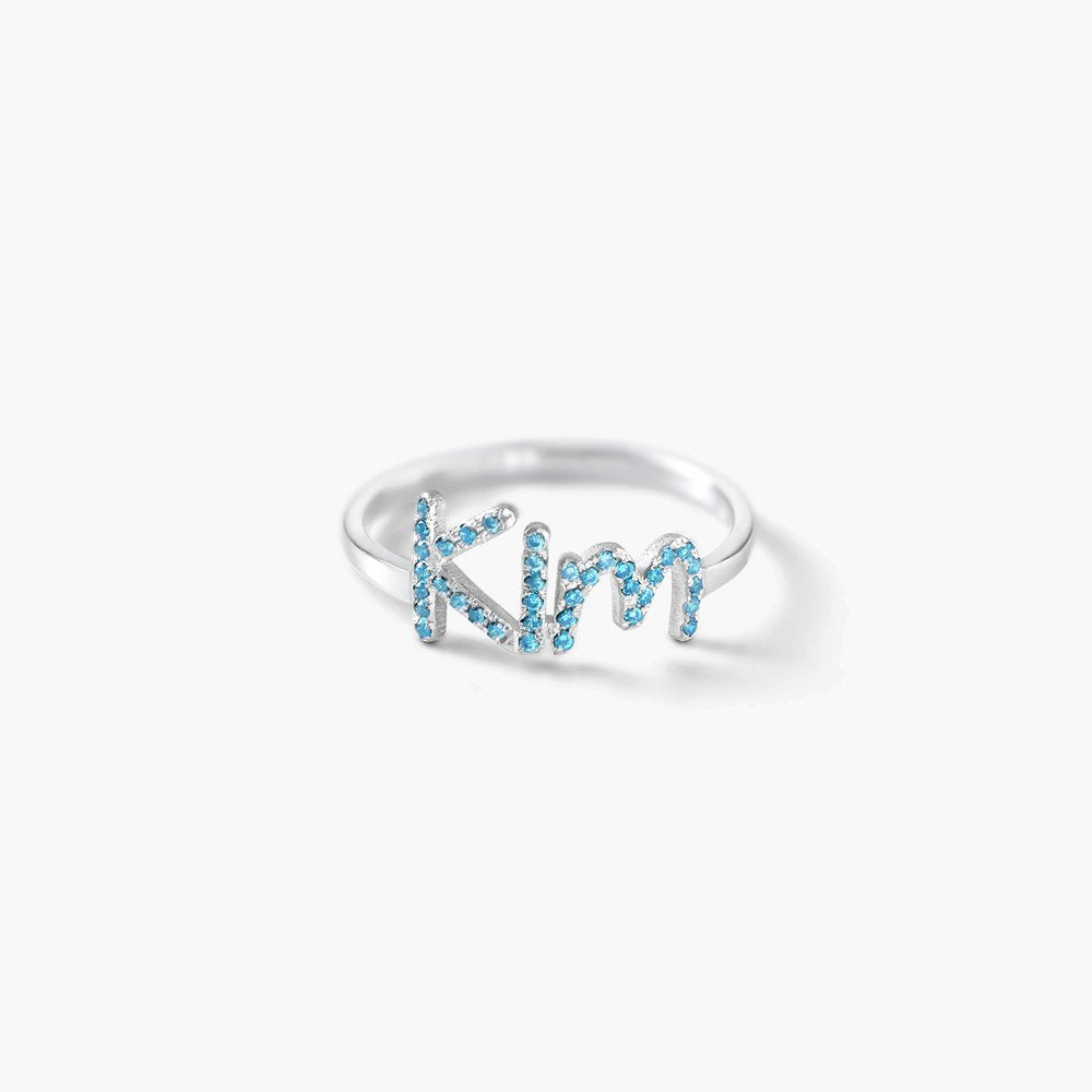 A beautiful 925 Sterling Silver Swarovski Stone Name Ring featuring personalized name and sparkling stones, available in silver, gold, and rose gold finishes.
