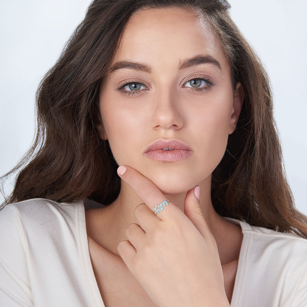 A beautiful 925 Sterling Silver Swarovski Stone Name Ring featuring personalized name and sparkling stones, available in silver, gold, and rose gold finishes.