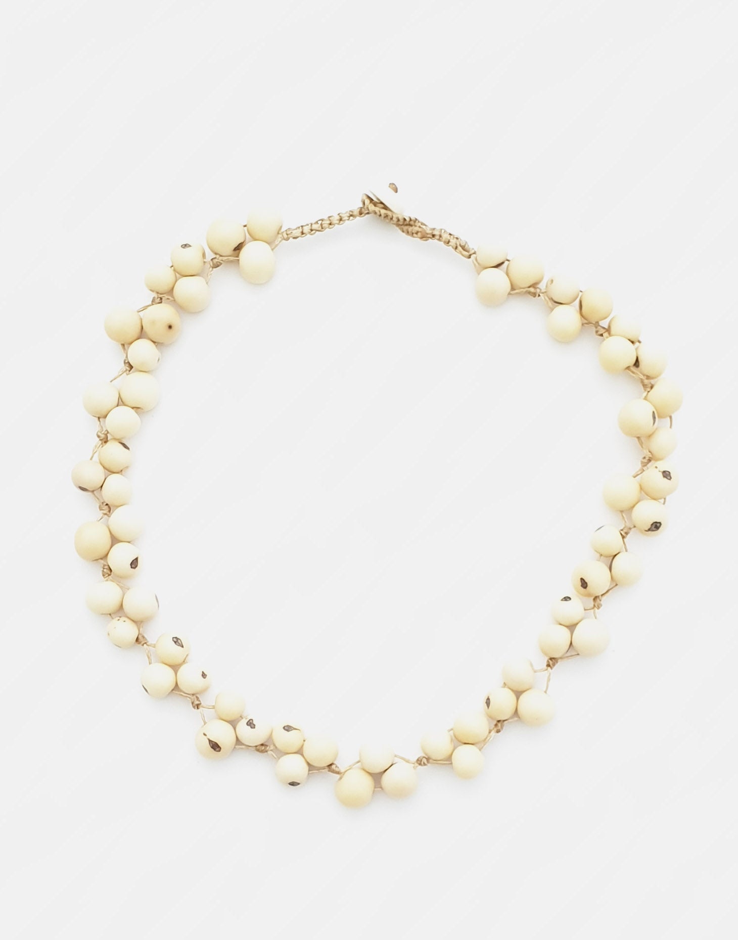 A colorful Acai Berry Short Necklace made from organic acai seeds, showcasing a delicate and lightweight design.