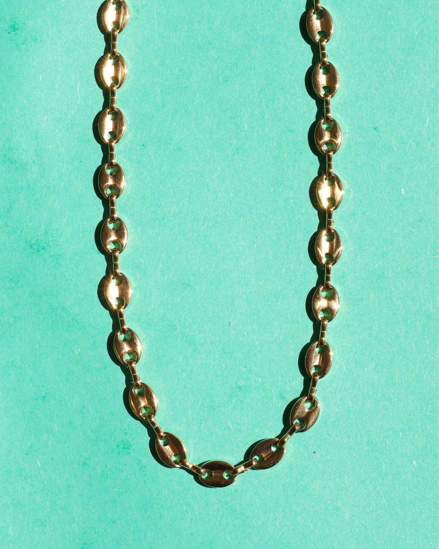 Achaz Coffee Bean Necklace featuring a delicate gold design on stainless steel, perfect for layering or solo wear.