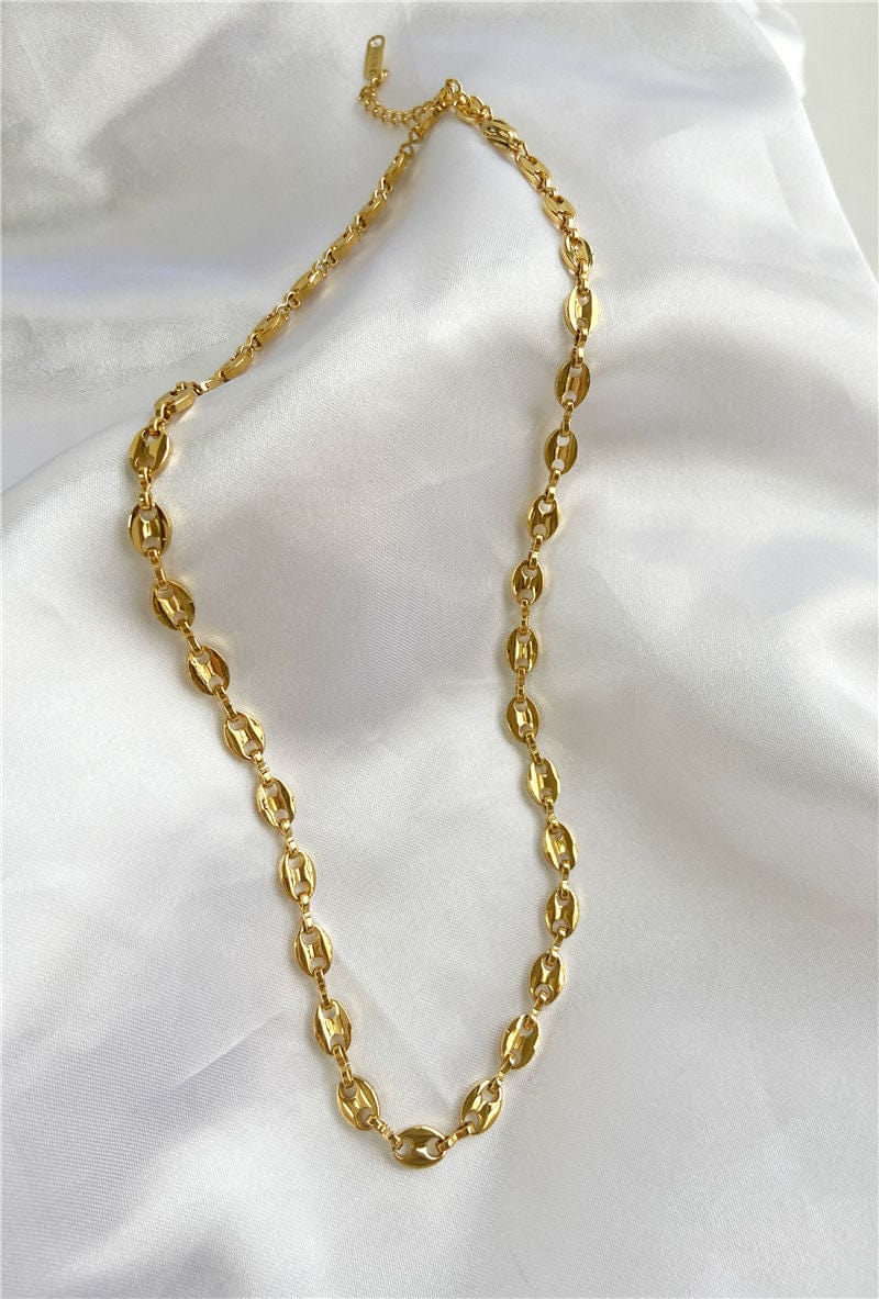 Achaz Coffee Bean Necklace featuring a delicate gold design on stainless steel, perfect for layering or solo wear.