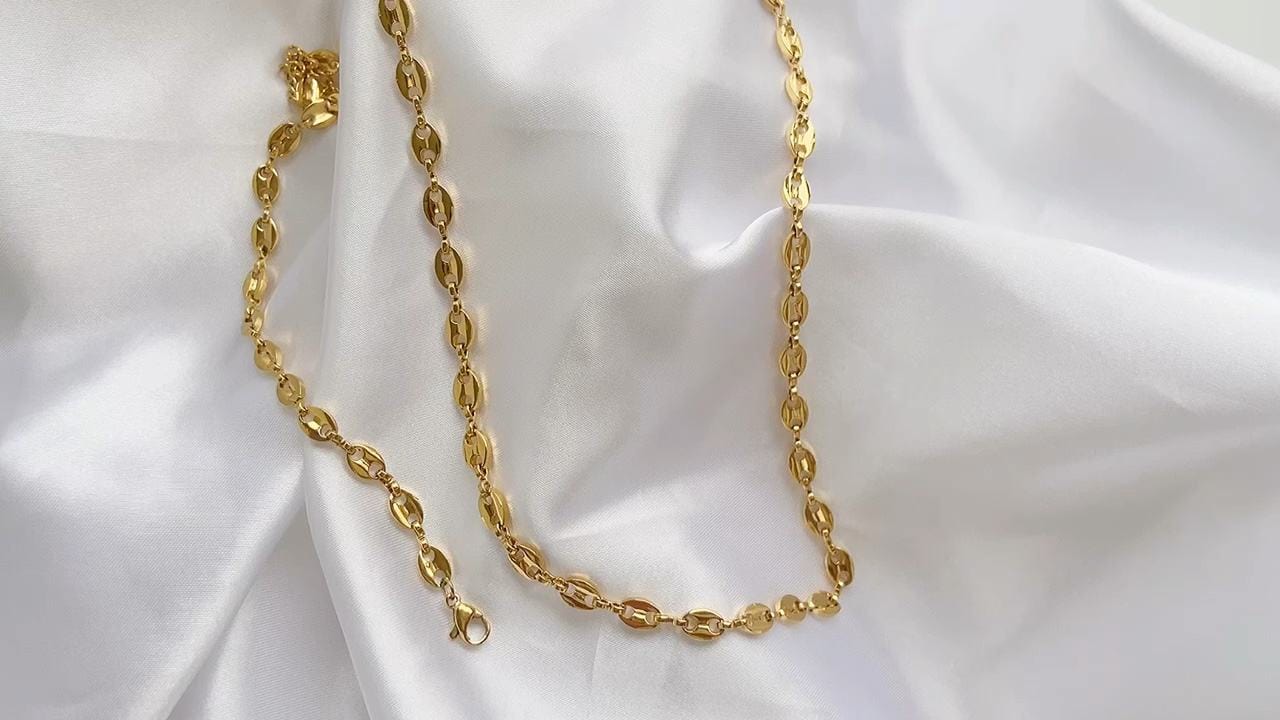 Achaz Coffee Bean Necklace featuring a delicate gold design on stainless steel, perfect for layering or solo wear.