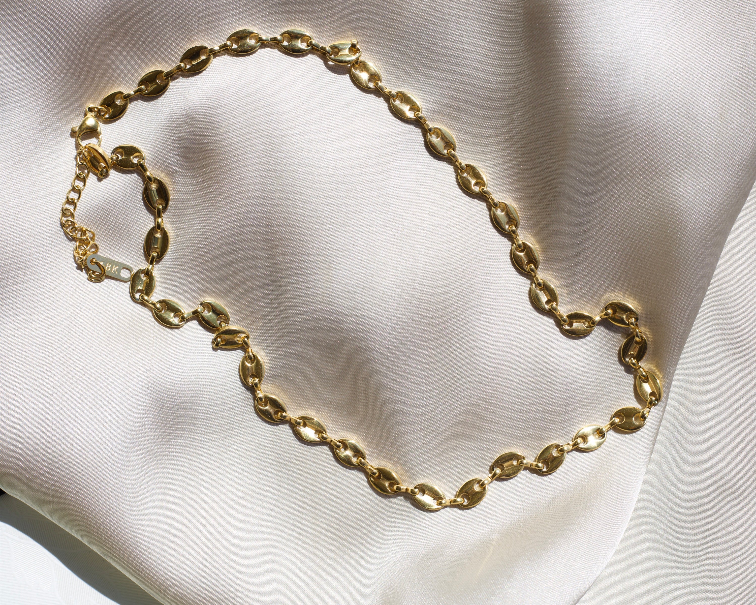 Achaz Coffee Bean Necklace featuring a delicate gold design on stainless steel, perfect for layering or solo wear.