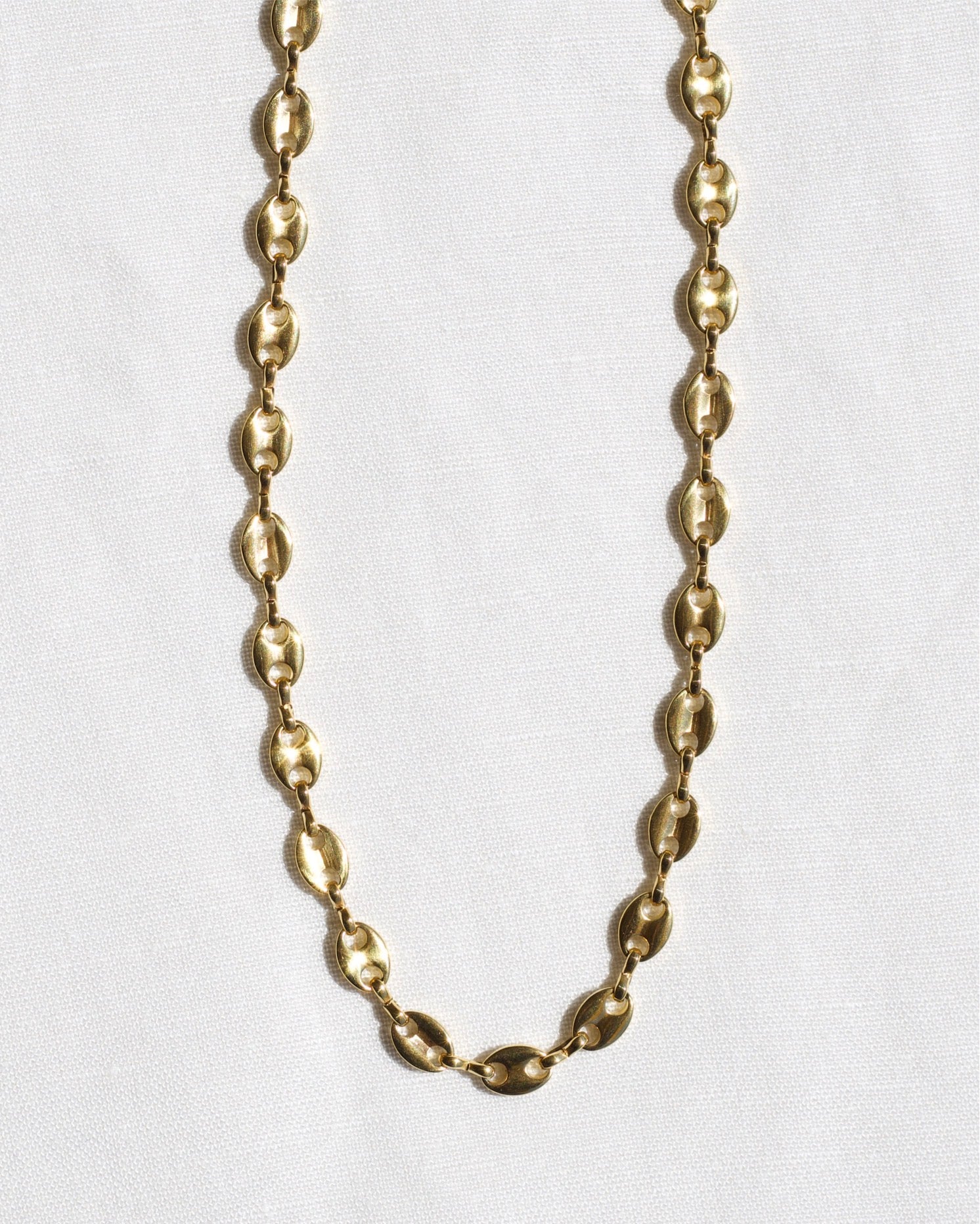 Achaz Coffee Bean Necklace featuring a delicate gold design on stainless steel, perfect for layering or solo wear.