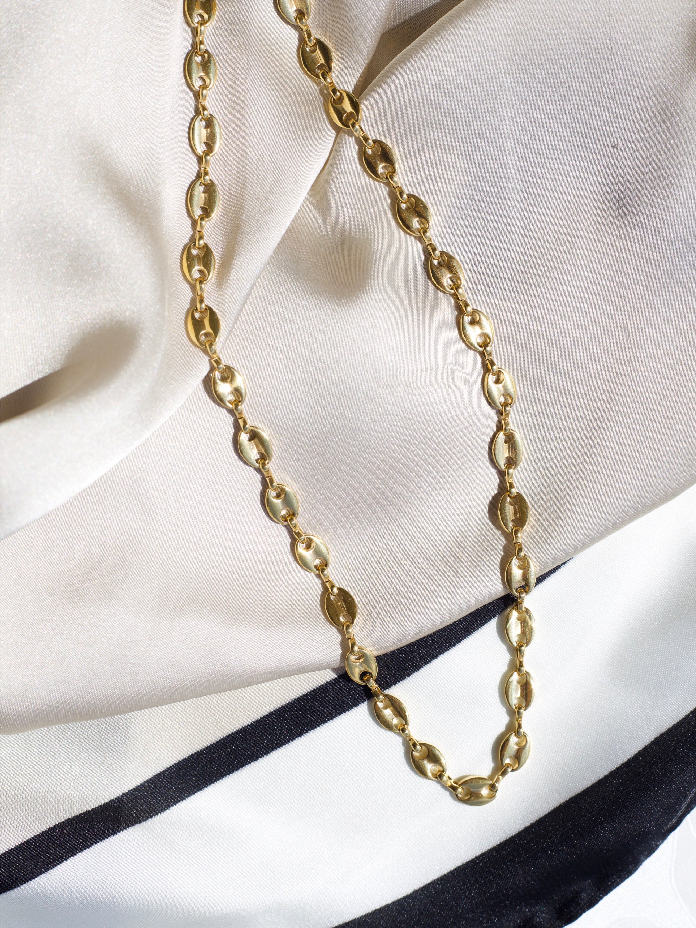 Achaz Coffee Bean Necklace featuring a delicate gold design on stainless steel, perfect for layering or solo wear.