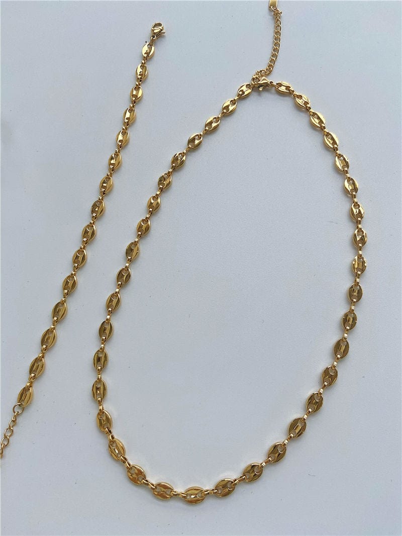 Achaz Coffee Bean Necklace featuring a delicate gold design on stainless steel, perfect for layering or solo wear.