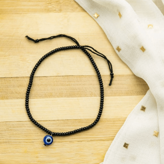 Adjustable Black Threaded Bead Blue Evil Eye Indian Nazaria Dangle Anklet featuring black beads and a blue evil eye charm.