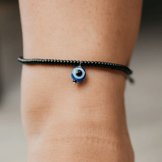 Adjustable Black Threaded Bead Blue Evil Eye Indian Nazaria Dangle Anklet featuring black beads and a blue evil eye charm.