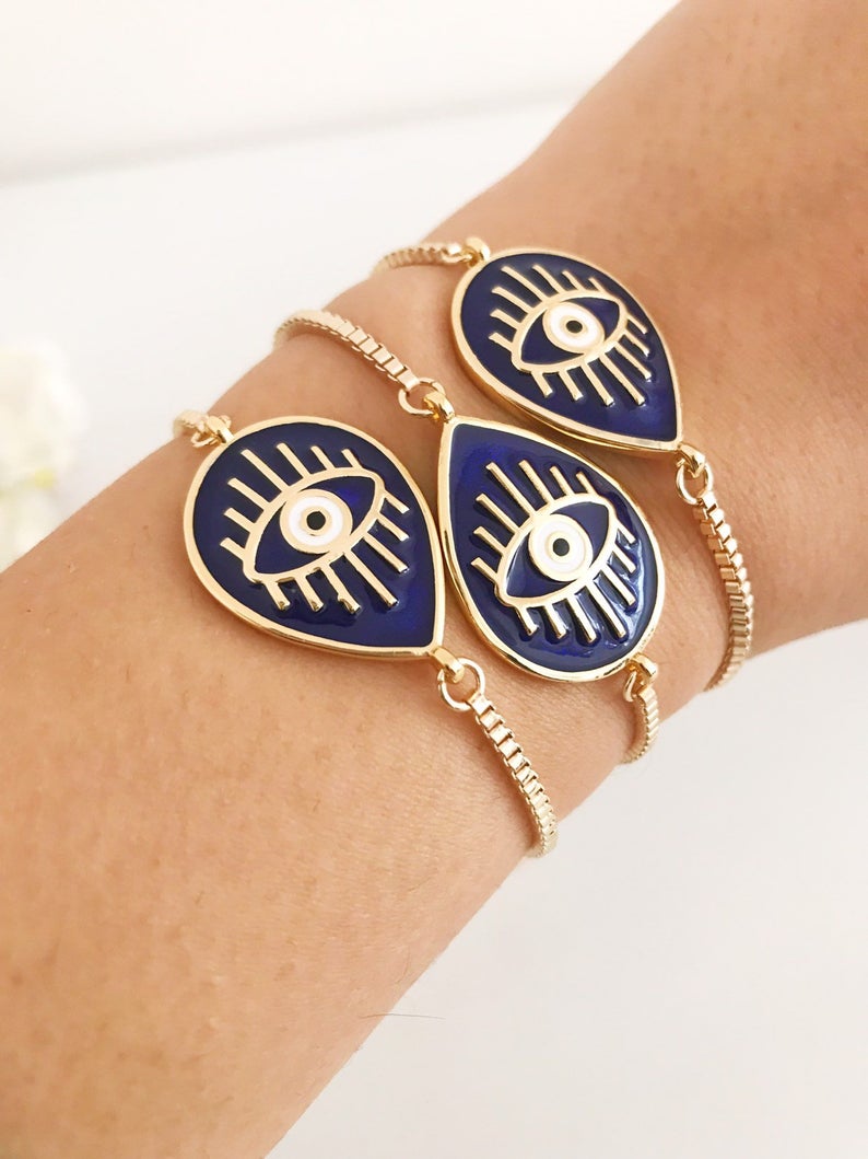 Adjustable Evil Eye Bracelet featuring blue and white evil eye charm on a stainless steel band, showcasing its elegant design and adjustable feature.