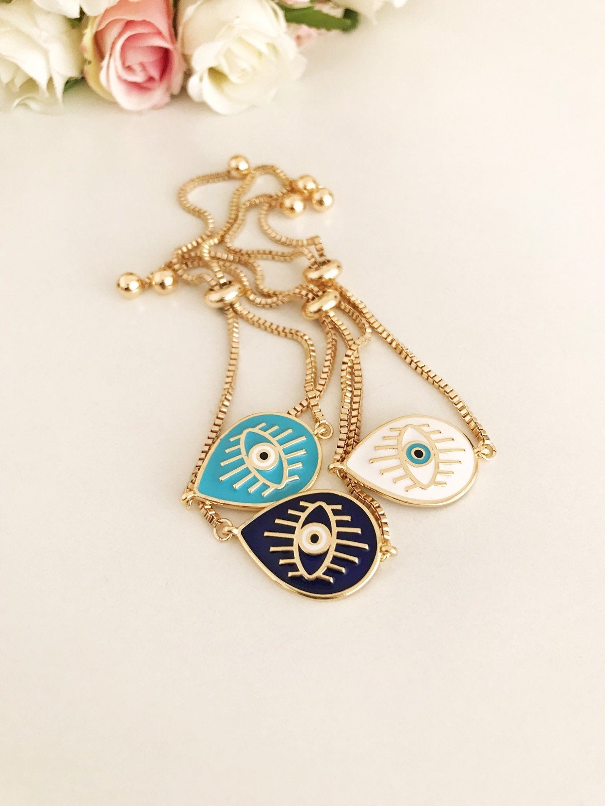 Adjustable Evil Eye Bracelet featuring blue and white evil eye charm on a stainless steel band, showcasing its elegant design and adjustable feature.