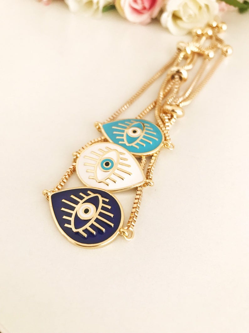 Adjustable Evil Eye Bracelet featuring blue and white evil eye charm on a stainless steel band, showcasing its elegant design and adjustable feature.