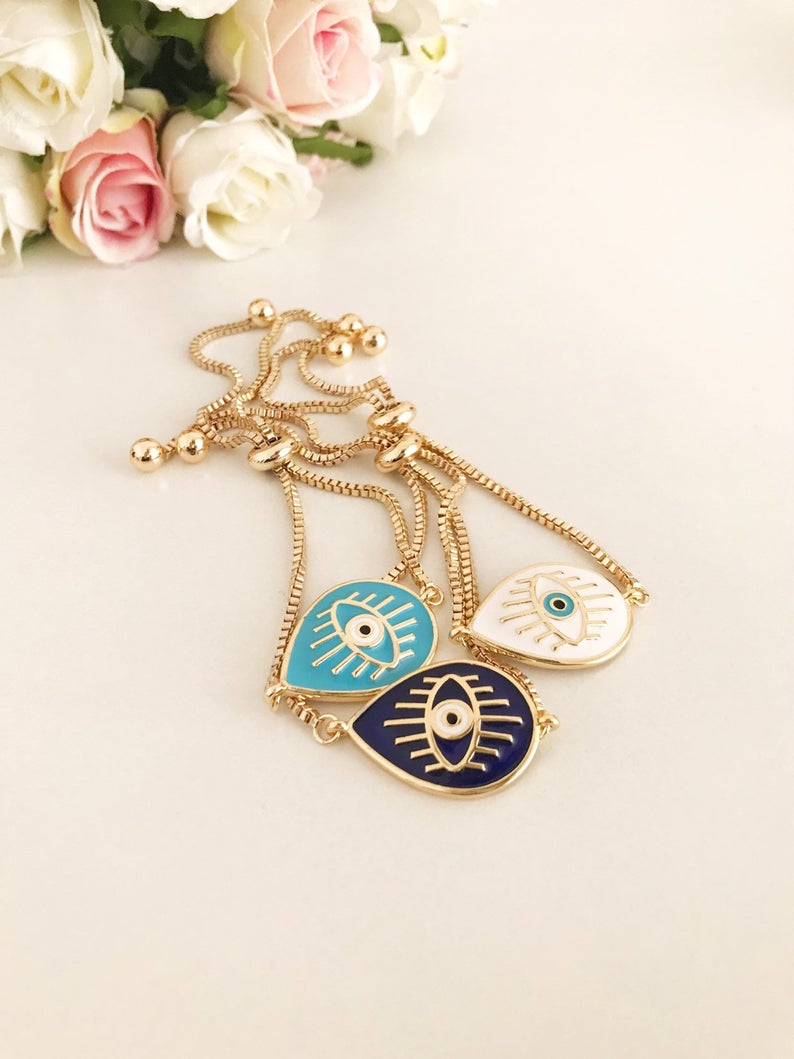 Adjustable Evil Eye Bracelet featuring blue and white evil eye charm on a stainless steel band, showcasing its elegant design and adjustable feature.