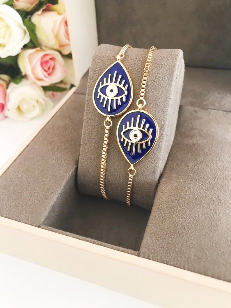 Adjustable Evil Eye Bracelet featuring blue and white evil eye charm on a stainless steel band, showcasing its elegant design and adjustable feature.