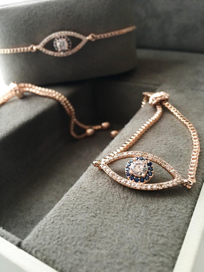 Adjustable Evil Eye Bracelet in rose gold with zircon charm, showcasing its elegant design and adjustable feature.
