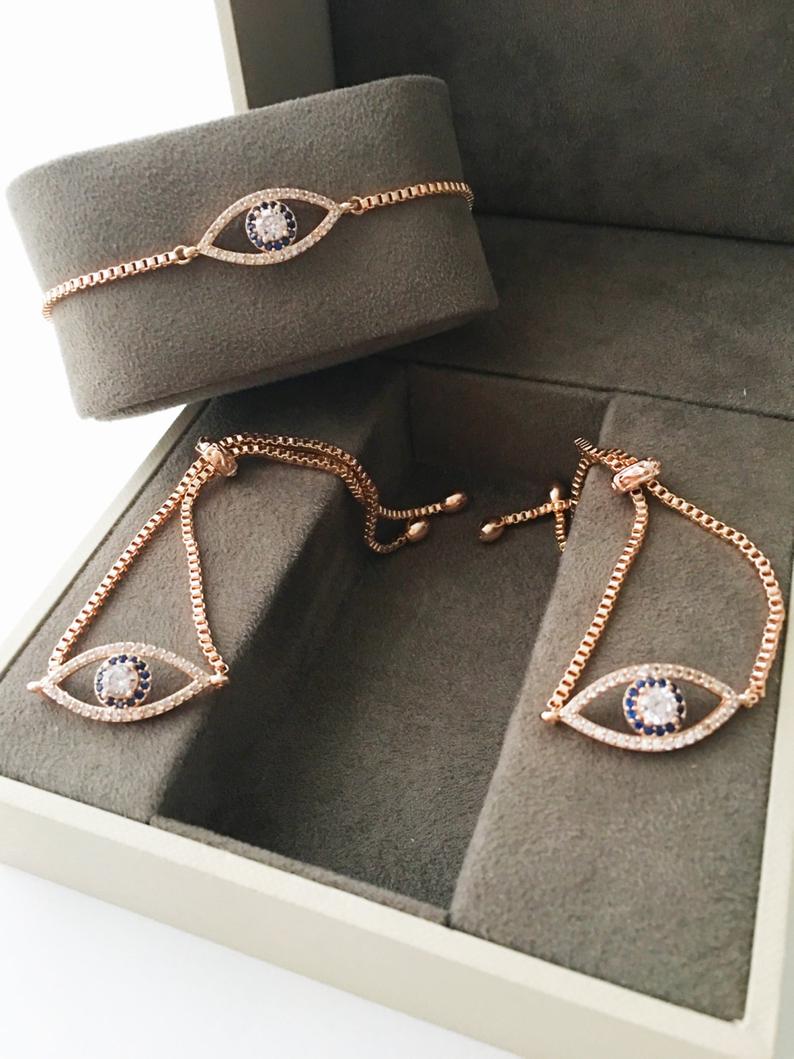 Adjustable Evil Eye Bracelet in rose gold with zircon charm, showcasing its elegant design and adjustable feature.