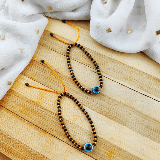 Adjustable Evil Eye Gold Black Beads Nazaria Bracelet for kids, featuring dark beads and protective evil eye charms.
