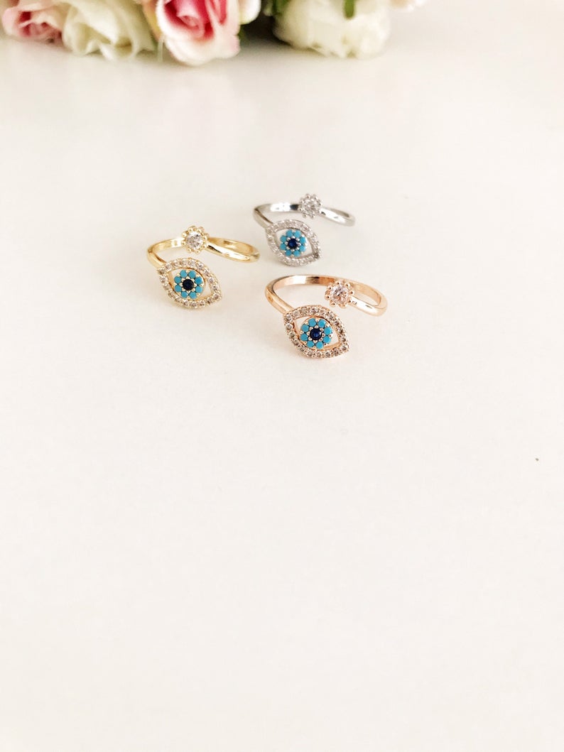 Adjustable Evil Eye Ring featuring a zircon charm in rose gold, showcasing its minimalist design and adjustable band.