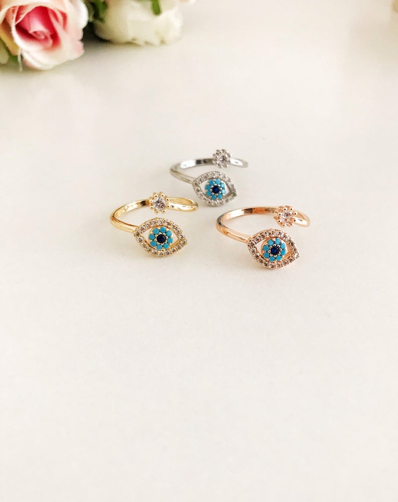Adjustable Evil Eye Ring featuring a zircon charm in rose gold, showcasing its minimalist design and adjustable band.