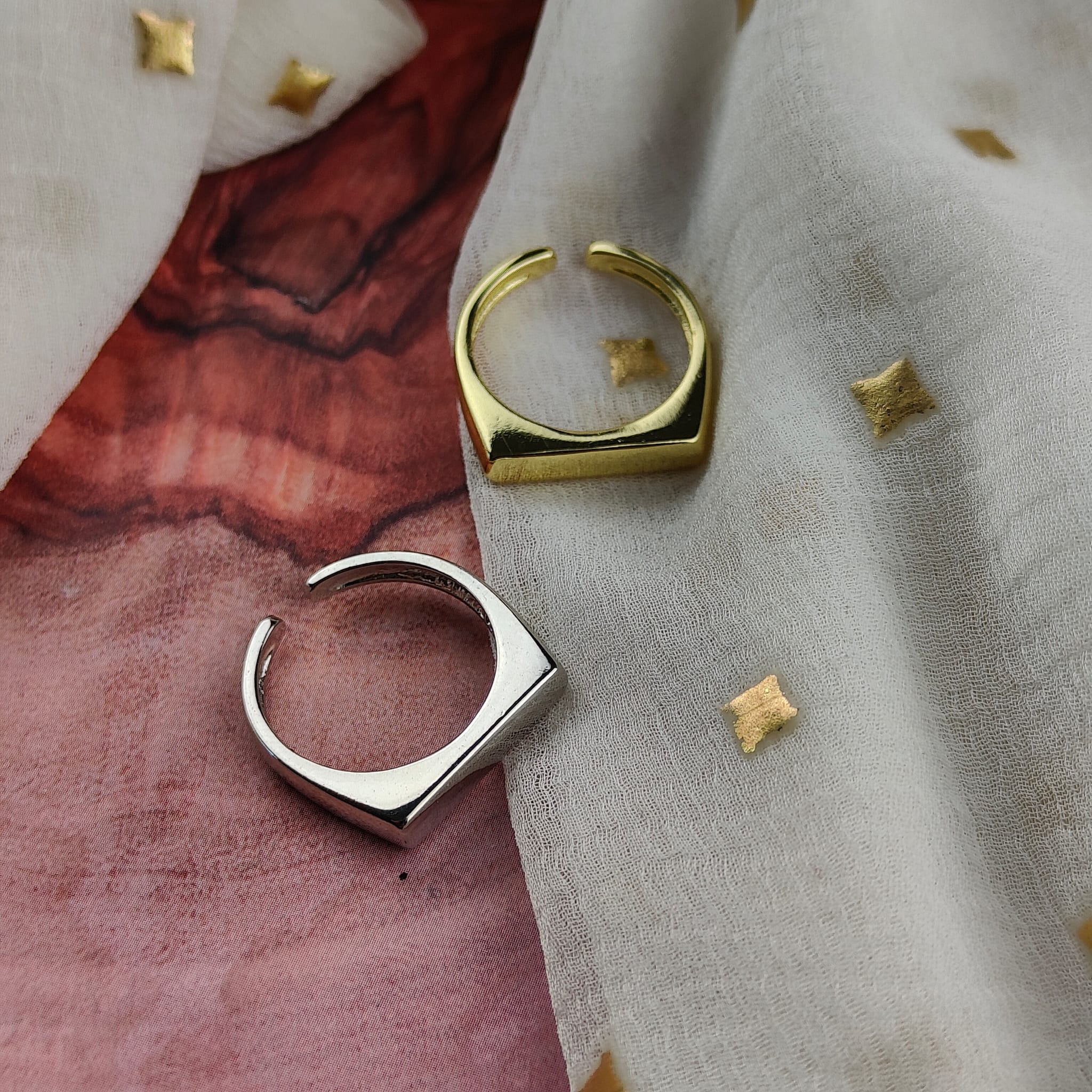 Adjustable Flat Top Square Thin Open Sterling Silver Signet Ring displayed on a soft fabric background, showcasing its elegant design and shiny finish.