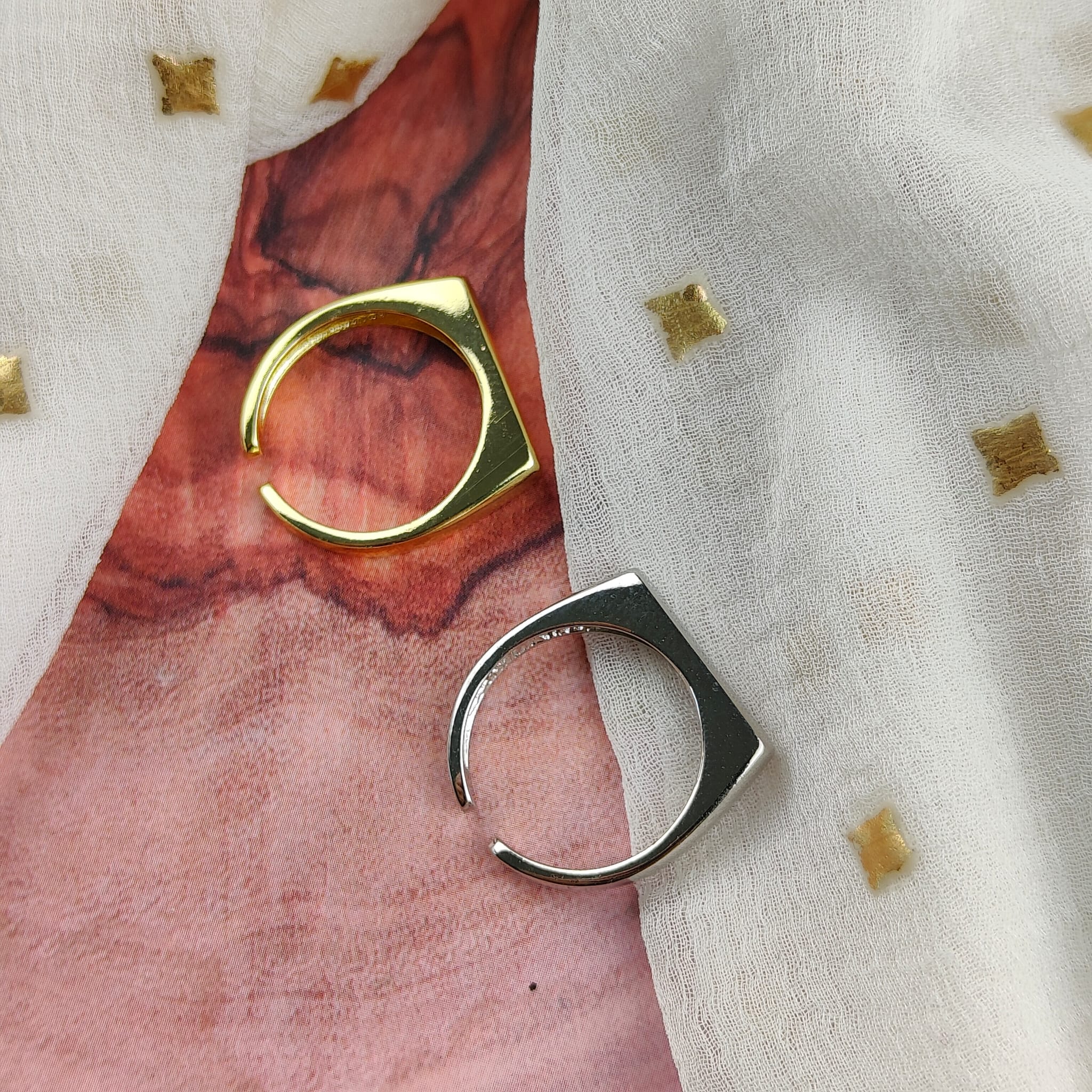 Adjustable Flat Top Square Thin Open Sterling Silver Signet Ring displayed on a soft fabric background, showcasing its elegant design and shiny finish.