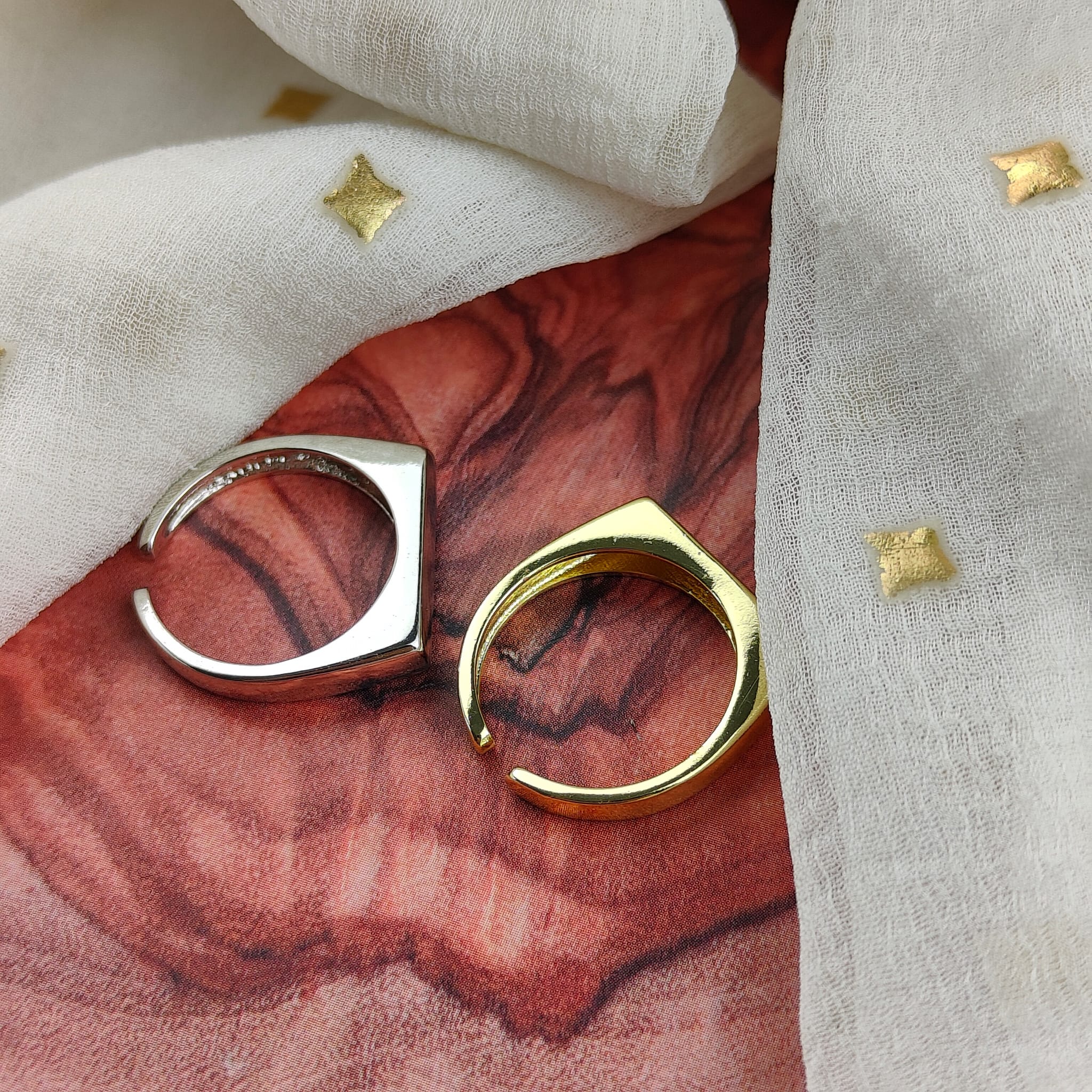 Adjustable Flat Top Square Thin Open Sterling Silver Signet Ring displayed on a soft fabric background, showcasing its elegant design and shiny finish.