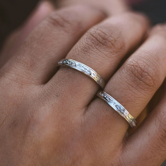 Adjustable silver engraved couple promise ring set showcasing minimalist design and elegant craftsmanship.