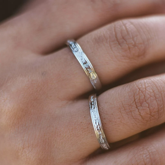 Adjustable silver engraved couple promise ring set showcasing minimalist design and elegant craftsmanship.