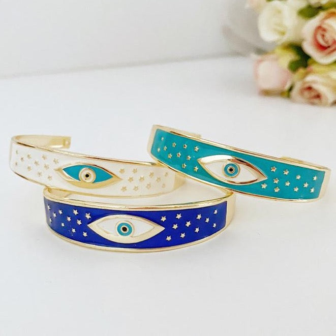 Adjustable Wide Cuff Bracelet featuring a movable Evil Eye charm in blue and gold, perfect for stacking.