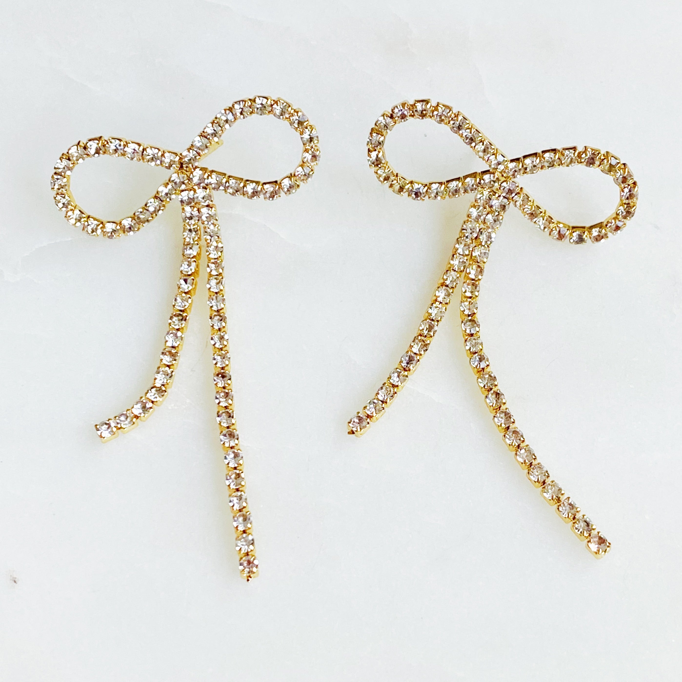Adorable Shine Bow Earrings featuring a delicate bow design with sparkling cubic zirconia, elegantly crafted in 18K gold plated brass.