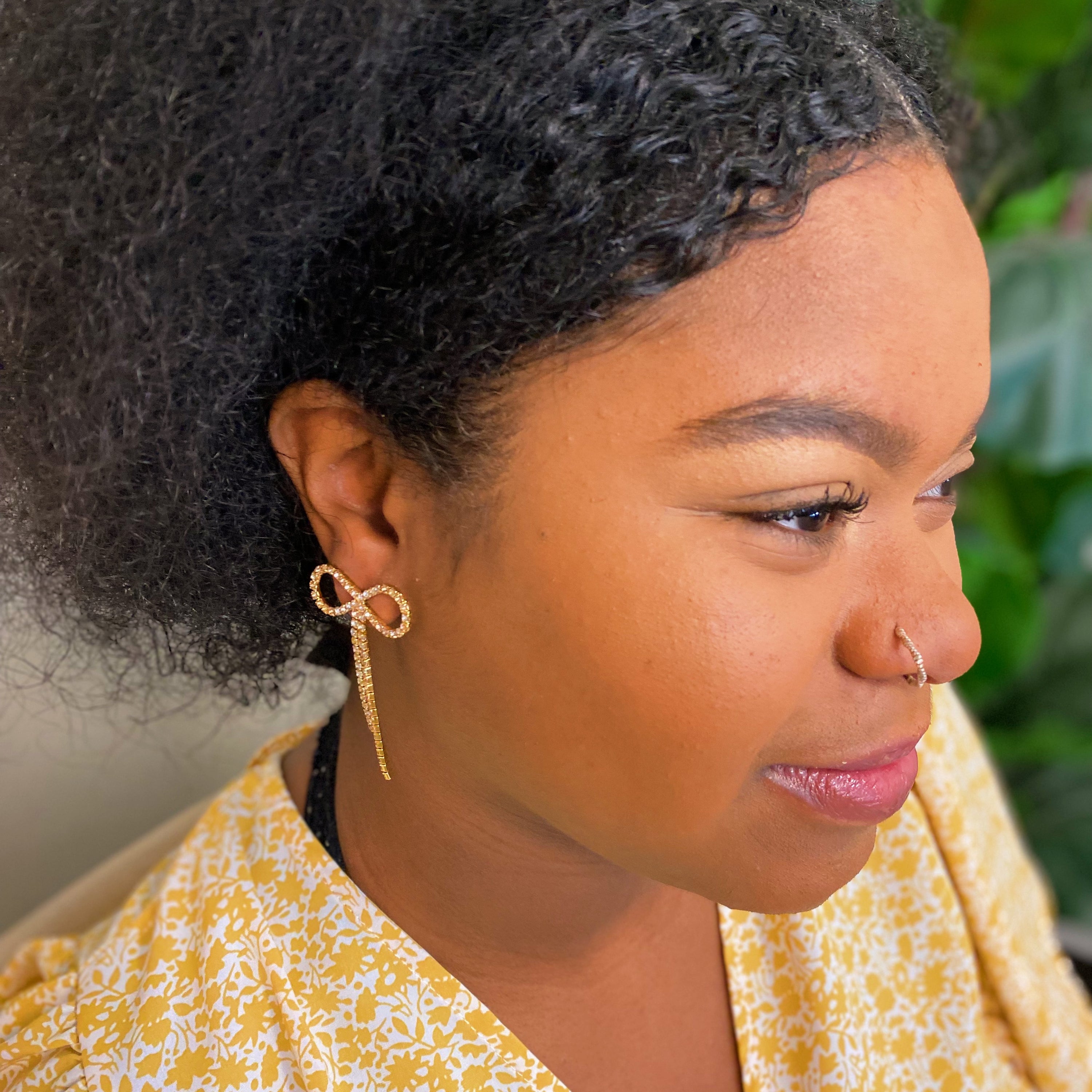 Adorable Shine Bow Earrings featuring a delicate bow design with sparkling cubic zirconia, elegantly crafted in 18K gold plated brass.