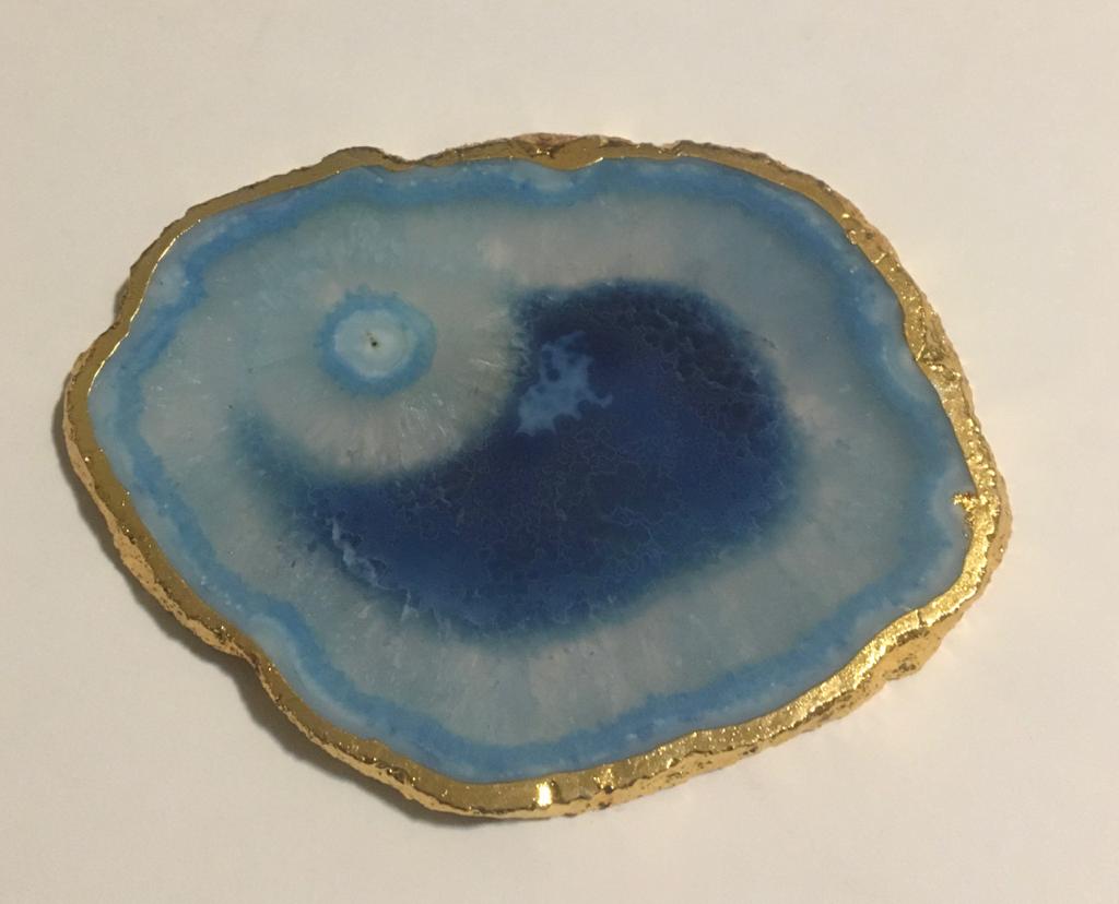 Set of hand-polished blue agate coasters with unique patterns and gilded golden edges, perfect for home decor.