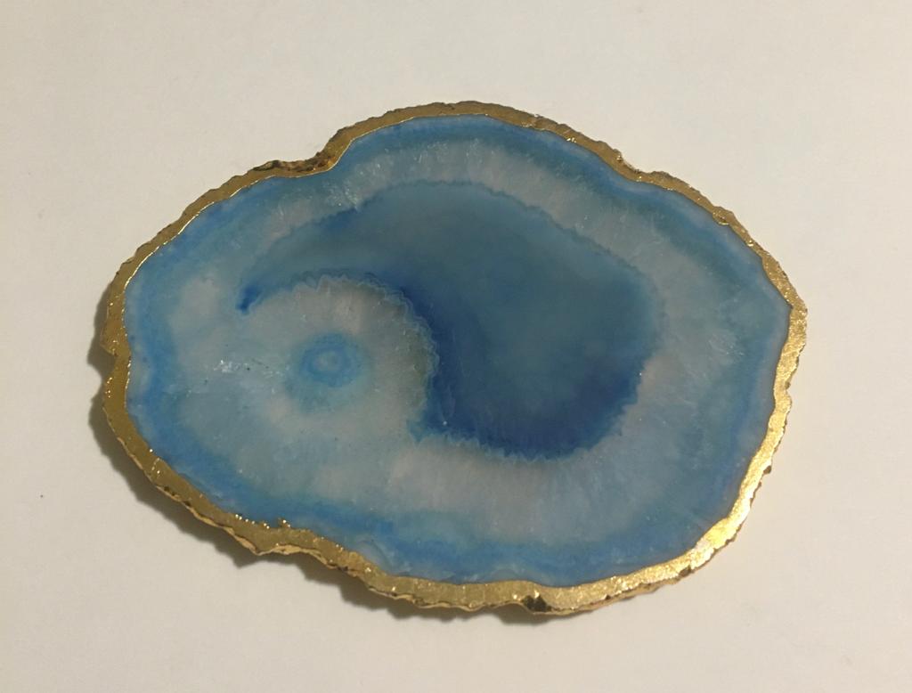 Set of hand-polished blue agate coasters with unique patterns and gilded golden edges, perfect for home decor.