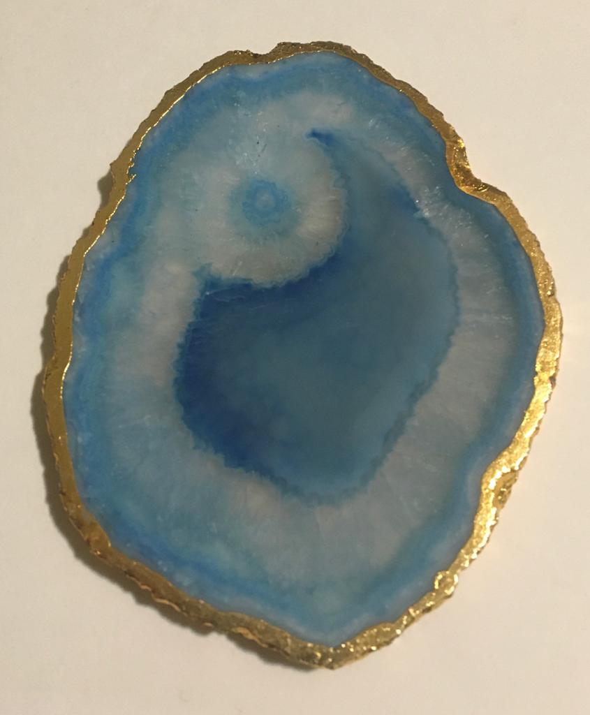 Set of hand-polished blue agate coasters with unique patterns and gilded golden edges, perfect for home decor.