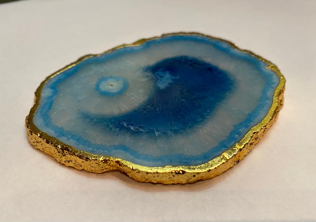Set of hand-polished blue agate coasters with unique patterns and gilded golden edges, perfect for home decor.