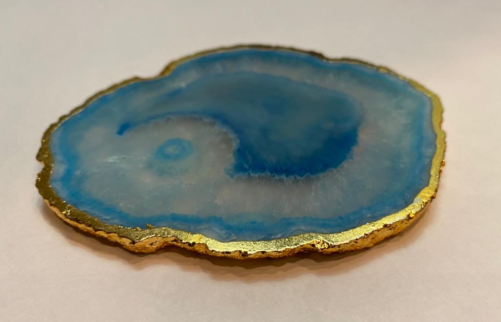 Set of hand-polished blue agate coasters with unique patterns and gilded golden edges, perfect for home decor.