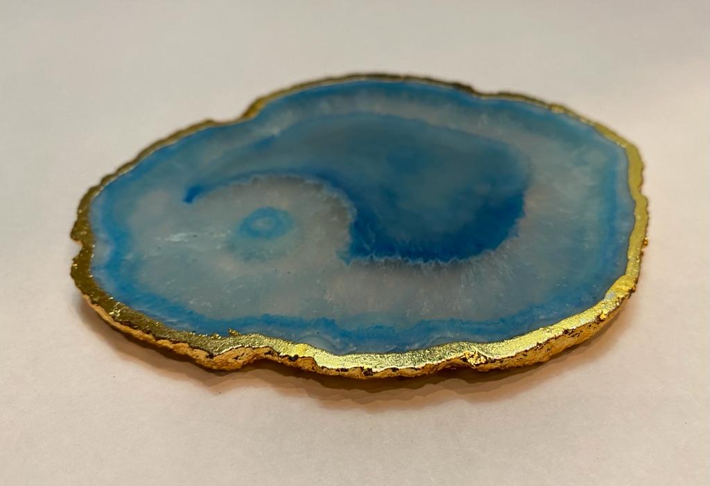 Set of hand-polished blue agate coasters with unique patterns and gilded golden edges, perfect for home decor.