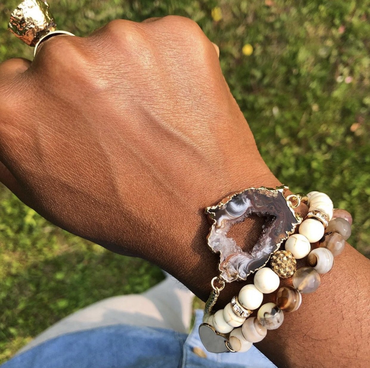 A stylish Agate Geode Adjustable Bracelet featuring unique black and white agate slices, gold beads, and tiny rhinestone charms.