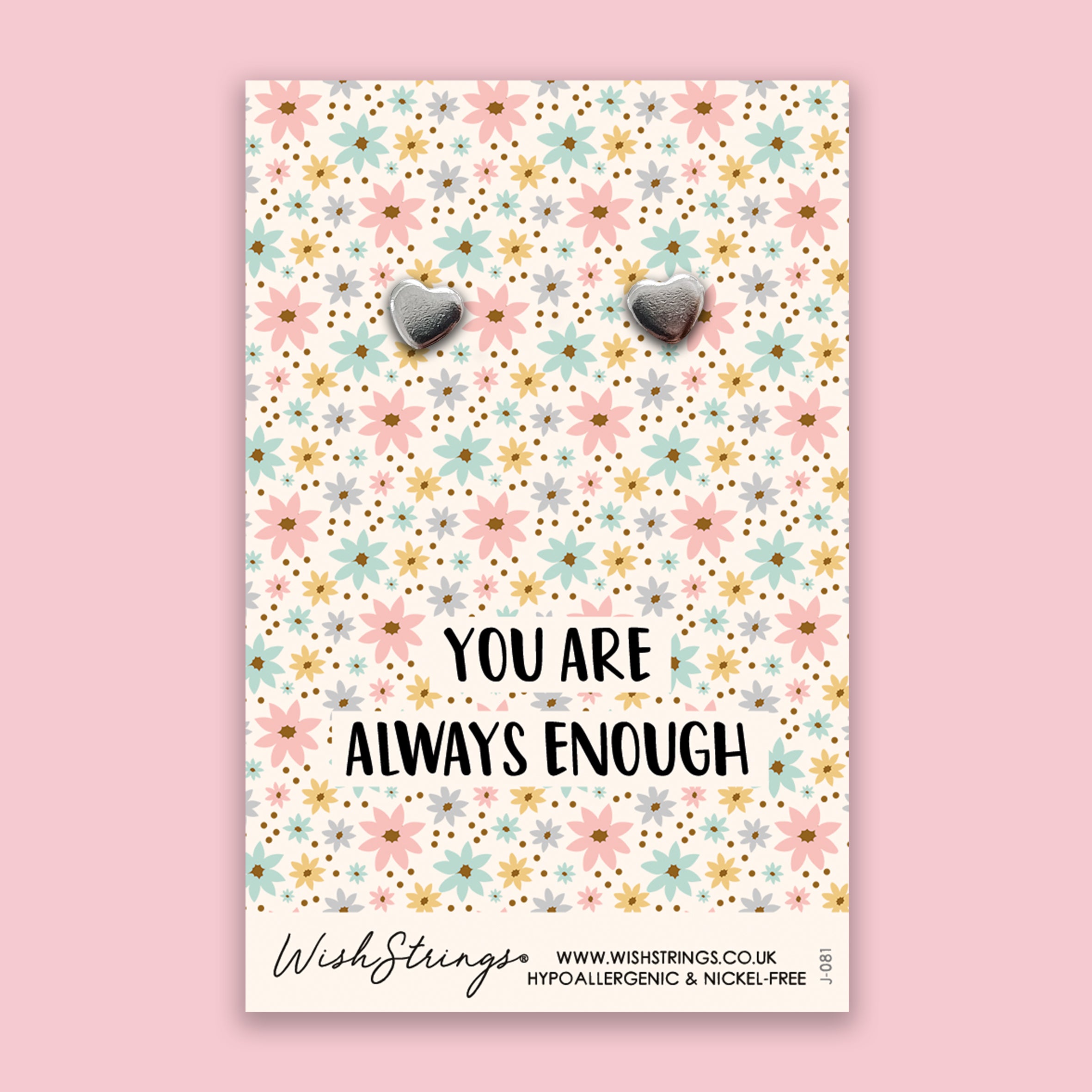 A pair of elegant silver heart stud earrings made from 304 stainless steel, beautifully displayed on a gift card.